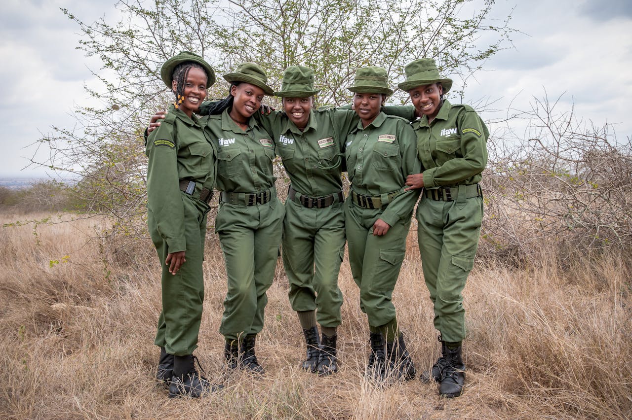 Smiling team of female wildlife rangers in Kenya, promoting conservation efforts.